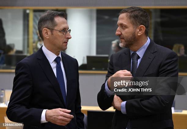 Hungarian Deputy Prime Minister and Finance Minister Mihaly Varga talks with Slovenian Finance Minister Klemen Bostjancic on the sidelines of an...