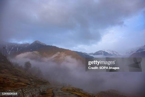 Clouds engulf the mountains on the outskirts of Srinagar on a cold autumn day. Rains continued to lash plains while upper reaches received snowfall...