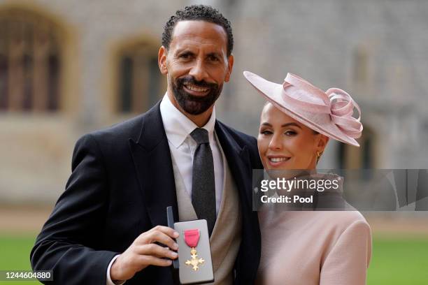 Rio Ferdinand and his wife Kate Ferdinand after being made an Officer of the Order of the British Empire by the Prince of Wales during an investiture...