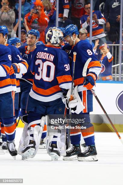 Noah Dobson of the New York Islanders celebrates his game winning overtime goal with Ilya Sorokin against the Calgary Flames at UBS Arena on November...