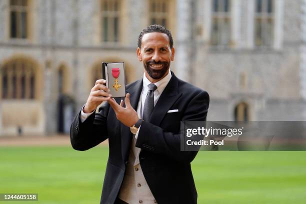 Rio Ferdinand poses after being made an Officer of the Order of the British Empire by the Prince of Wales during an investiture ceremony at Windsor...