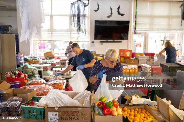 Volunteers sort food into food parcels at the Rumney Forum community charity on November 8, 2022 in Cardiff, United Kingdom. The Rumney Forum is a...