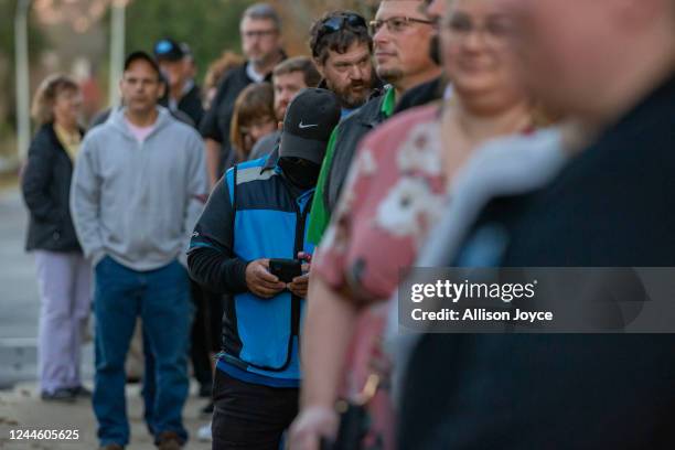 People wait in line to vote at a polling place on November 8, 2022 in Fuquay Varina, North Carolina, United States. After months of candidates...