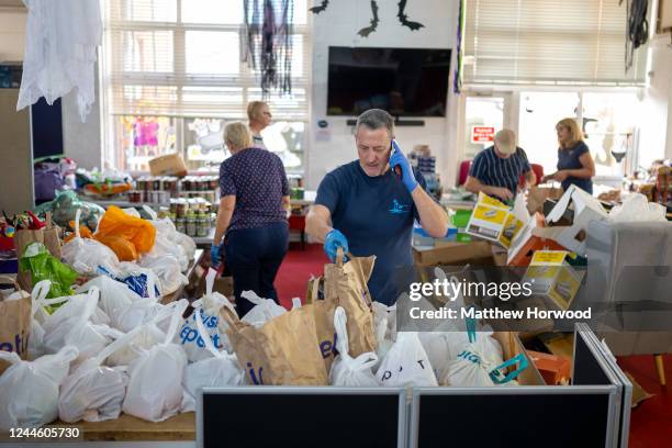 Volunteers sort food into food parcels at the Rumney Forum community charity on November 8, 2022 in Cardiff, United Kingdom. The Rumney Forum is a...