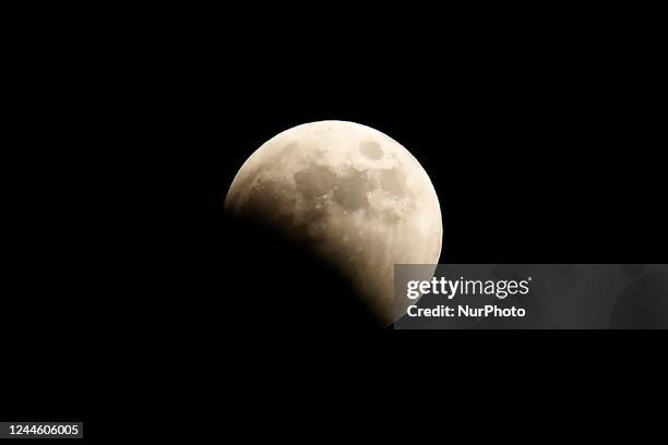 Nov 8, 2022-Sangju, South Korea-A Partial lunar eclipse, in which part of the moon is covered by the Earth's shadow, is seen in the sky of Sangju,...