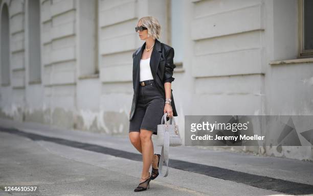 Karin Teigl wearing Bottega Veneta heels, Arket jeans short, Dior belt and chain, Skims shirt, Dior bag and Zara blazer on May 31, 2020 in Augsburg,...