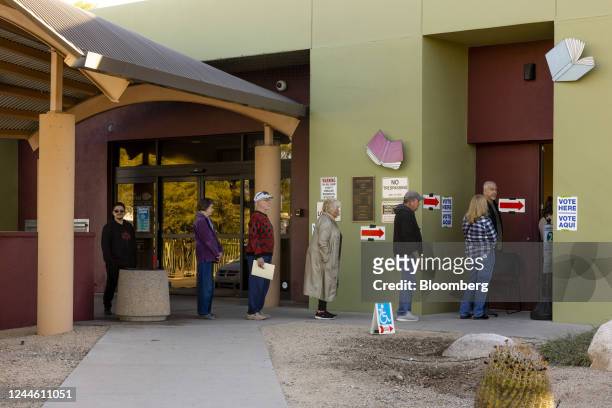 Voters wait in line outside a polling location in Tucson, Arizona, US, on Tuesday, Nov. 8, 2022. After months of talk about reproductive rights,...