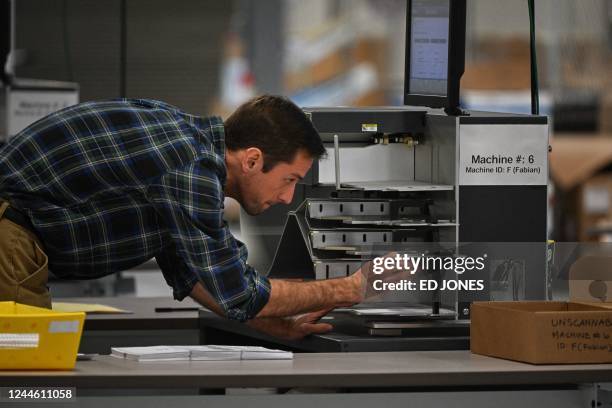 Ballots are loaded into a counting machine at an elections warehouse outside of Philadelphia, Pennsylvania, on November 8, 2022.