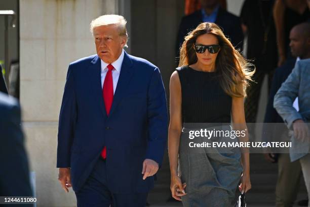 Former US President Donald Trump and his wife, Melania Trump, leave a polling station after voting in the US midterm elections in Palm Beach,...