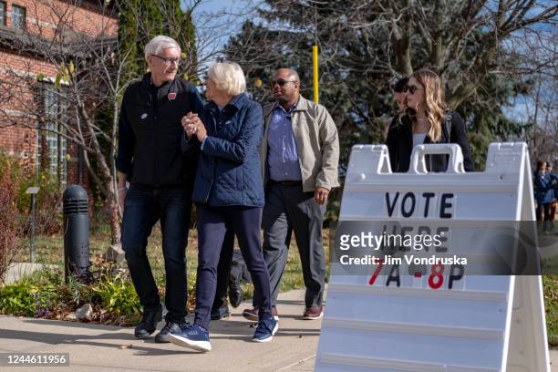 Wisconsin Governor Tony Evers and First Lady Kathy Evers leave a polling place at the Maple Bluff Village Center on November 8, 2022 in Madison,...