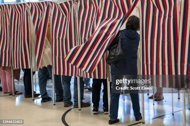 Voter enters a booth to fill out their ballot at Parker-Varney Elementary School on November 08, 2022 in Manchester, New Hampshire. After months of...