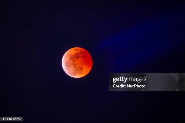 Astronomy enthusiasts observe the blood moon through telescopes during a total lunar eclipse viewing event in Manila, Philippines on 8 November 2022.