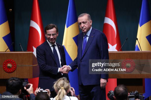 Turkish President Recep Tayyip Erdogan shakes hand with Swedish Prime Minister Ulf Kristersson during a press conference following their meeting at...