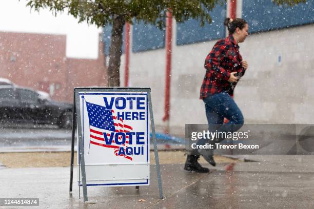 Washoe County voter runs through the snow to cast their ballot inside Reno High School on November 8, 2022 in Reno, Nevada. After months of...