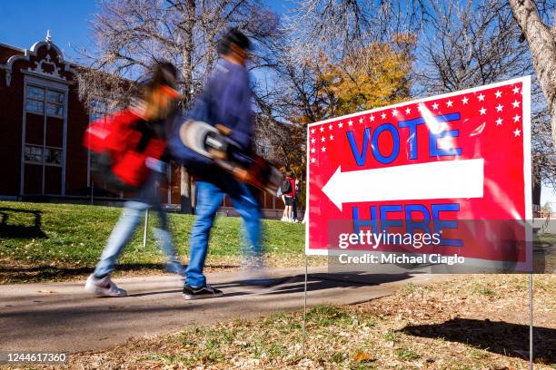 Students walk past a voting sign outside a polling location at Denver East High School on November 8, 2022 in Denver, Colorado. After months of...