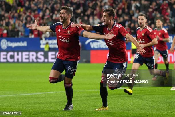 Osasuna's Spanish defender David Garcia celebrates with teammates after scoring his team's first goal during the Spanish league football match...