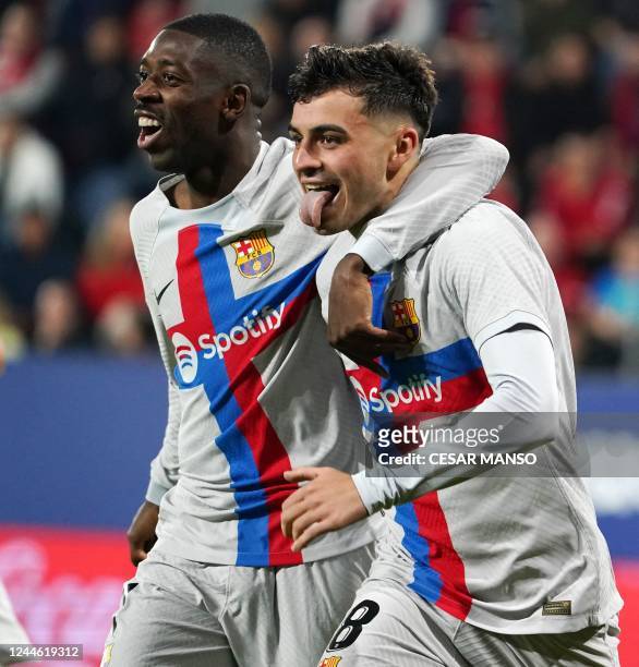 Barcelona's Spanish midfielder Pedri celebrates with Barcelona's French forward Ousmane Dembele after scoring his team's first goal during the...