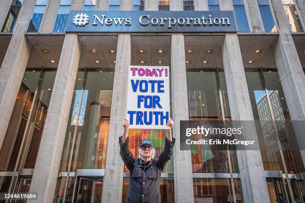 Participant seen holding a sign at the protest. On Election Day 2022, members of the activist groups Truth Tuesdays and Rise and Resist gathered at...