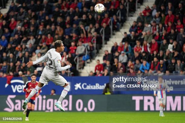 Barcelona's Brazilian forward Raphinha heads the ball and scores a goal during the Spanish league football match between CA Osasuna and FC Barcelona...