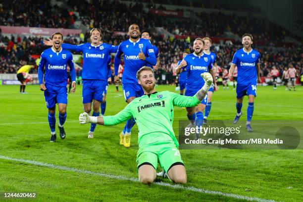 Gillingham players celebrate their sides victory after penalties during the Carabao Cup Third Round match between Brentford and Gillingham at...