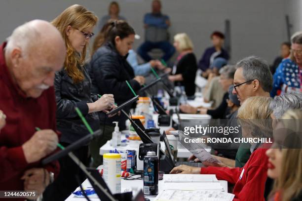 Nye County residents check in with volunteers prior to voting in the US Midterm elections at Bob Ruud Community Center in Pahrump, Nevada on November...