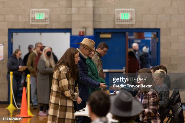 Voters stand in line to check in before casting their ballots at Reno High School in Washoe County on November 8, 2022 in Reno, Nevada. After months...