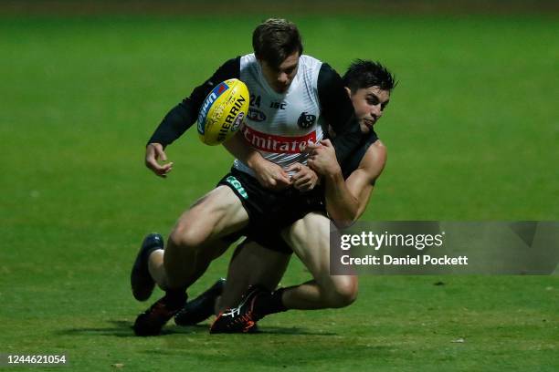 Josh Thomas is tackled by Brayden Maynard during a Collingwood Magpies AFL training session at Holden Centre on June 04, 2020 in Melbourne, Australia.