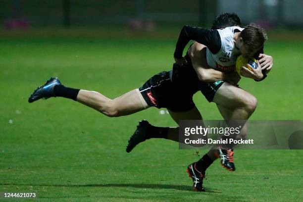 Josh Thomas is tackled by Brayden Maynard during a Collingwood Magpies AFL training session at Holden Centre on June 04, 2020 in Melbourne, Australia.