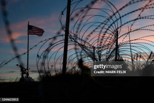 The American flag flies over barbed wire fence next to the Rio Grande River in Eagle Pass, Texas on November 8, 2022.