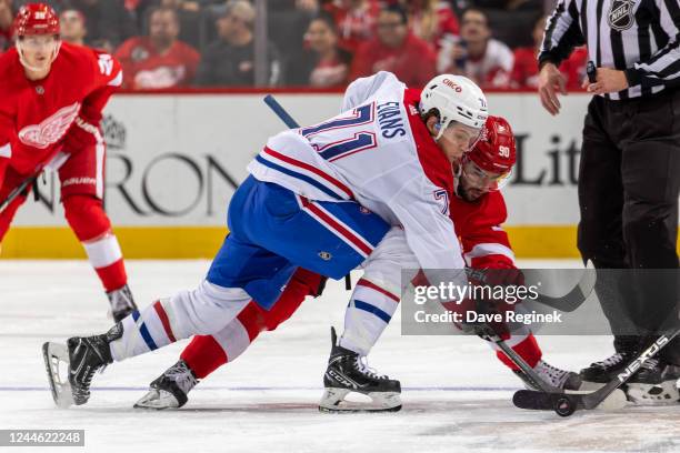 Jake Evans of the Montreal Canadiens wins a face-off against Joe Veleno of the Detroit Red Wings during the first period of an NHL game at Little...