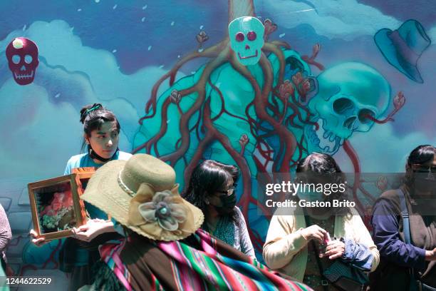 People walk next to a graffiti at Central Cemetery on November 8, 2022 in La Paz, Bolivia. "Las Ñatitas" is a traditional festivity celebrated every...