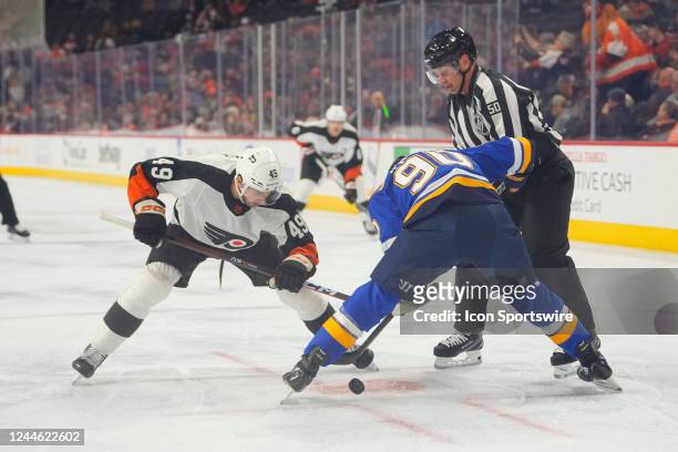 Philadelphia Flyers Left Wing Noah Cates and St. Louis Blues Center Ryan O'Reilly face off during the first period of the National Hockey League game...