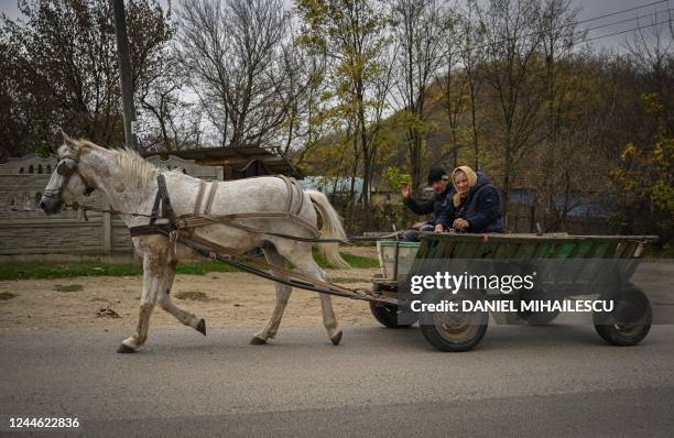 People drive a horse pulled cart in Tibirica village, November 2, 2022. - Faced with being starved of the Russian gas it has depended on for decades,...