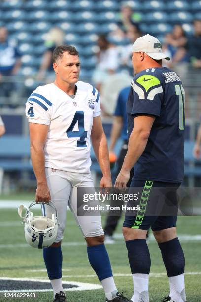 Indianapolis Colts kicker Adam Vinatieri talks with Seattle Seahawks kicker Sebastian Janikowski during an NFL preseason football game against the...