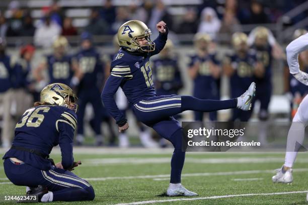 Akron Zips place kicker Cory Smigel kicks an extra point during the second quarter of the college football game between the Eastern Michigan Eagles...