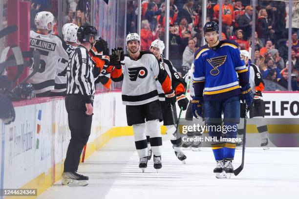 Noah Cates of the Philadelphia Flyers celebrates his second period goal against the St. Louis Blues with his teammates on the bench at the Wells...