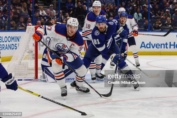 Erik Cernak of the Tampa Bay Lightning skates against Connor McDavid of the Edmonton Oilers during the third period at Amalie Arena on November 8,...