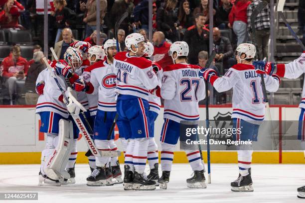 Teammates congratulate goalie Jake Allen of the Montreal Canadiens after an NHL game against the Detroit Red Wings at Little Caesars Arena on...