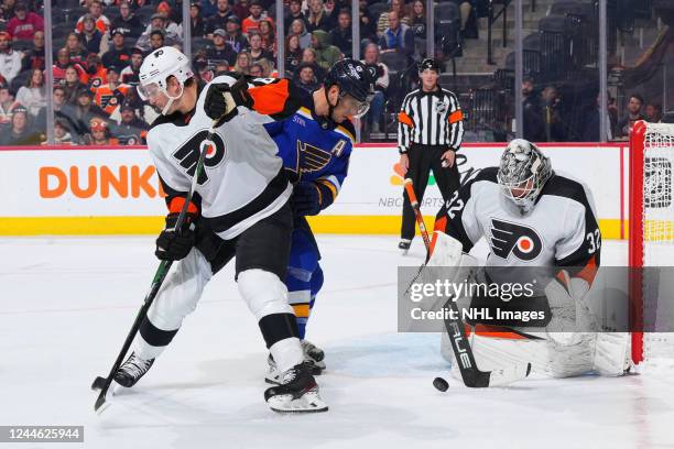Felix Sandstrom of the Philadelphia Flyers makes a stick save as Justin Braun defends against Brayden Schenn of the St. Louis Blues in the second...