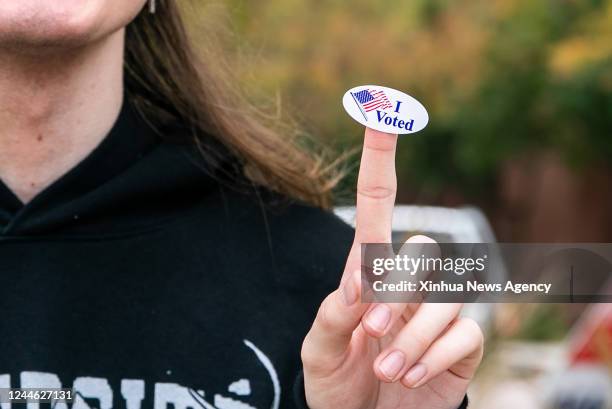 Young man who just voted shows his voting sticker in Plano, Texas, the United States, on Nov. 8, 2022. Concerned voters across the United States cast...