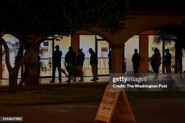 Voters are wait in line at a polling station at the Guadalupe Mercado shopping mall on November 8, 2022 in Guadalupe, Arizona. Today is the final day...