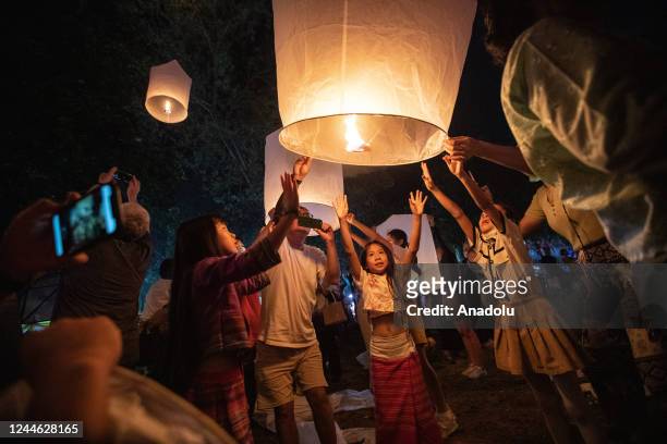 Family releases a lantern during Yi Peng Festival & Loy Kratong in Doi Saket, Chiang Mai, Thailand on November 08, 2022. In the north of Thailand,...