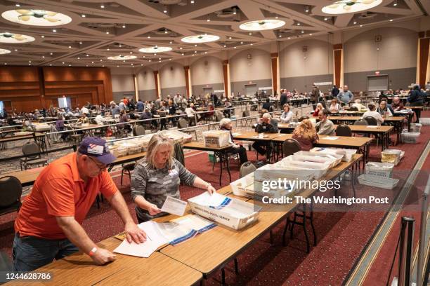 Volunteers check absentee ballots from Milwaukee County at Central Count, in Downtown Milwaukee, on November 8, 2022.