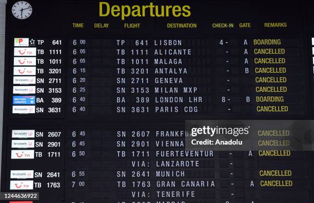 View of an announcement board at the departure hall of Brussels Airport as the public transport workers go on strike amid rising living costs driven...
