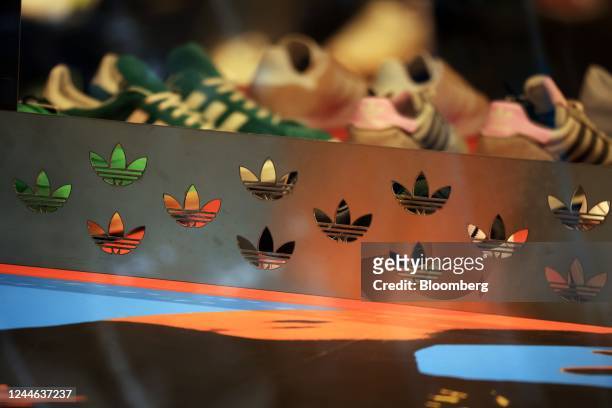 The logo of Adidas AG in the window of a store in Berlin, Germany, on Wednesday, Nov. 9, 2022. Adidas slashed its profitability forecast for the...