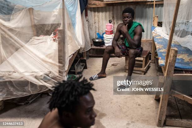 Construction workers from Sierra Leone sit in their room at a camp in Diamniadio on November 8, 2022. - With the large demand from labour in...