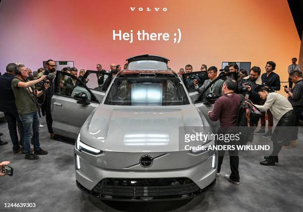 Journalists surround the new Volvo EX90, the company's new electric SUV, during a launch event in Stockholm, Sweden, on November 09, 2022. - Sweden...