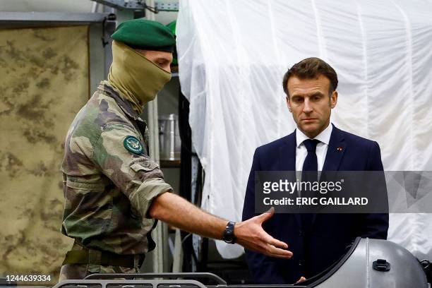 French President Emmanuel Macron speaks with a soldier of the French Commando Hubert, a special forces unit of the French Navy, in...