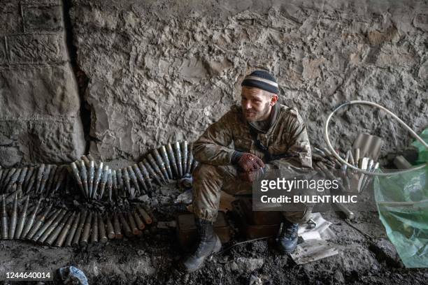 Ukrainian soldier sits near ammunition in Bakhmut, eastern Ukraine, on November 9 amid the Russian invasion of Ukraine.