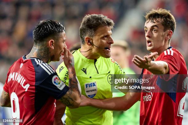 Aimar Oroz , Chimy Avila and referee react during the Spanish football of La Liga Santander, match between CA Osasuna and FC Barcelona at the Sadar...